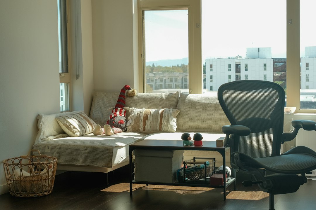 A cozy living room with a sofa, coffee table, and office chair